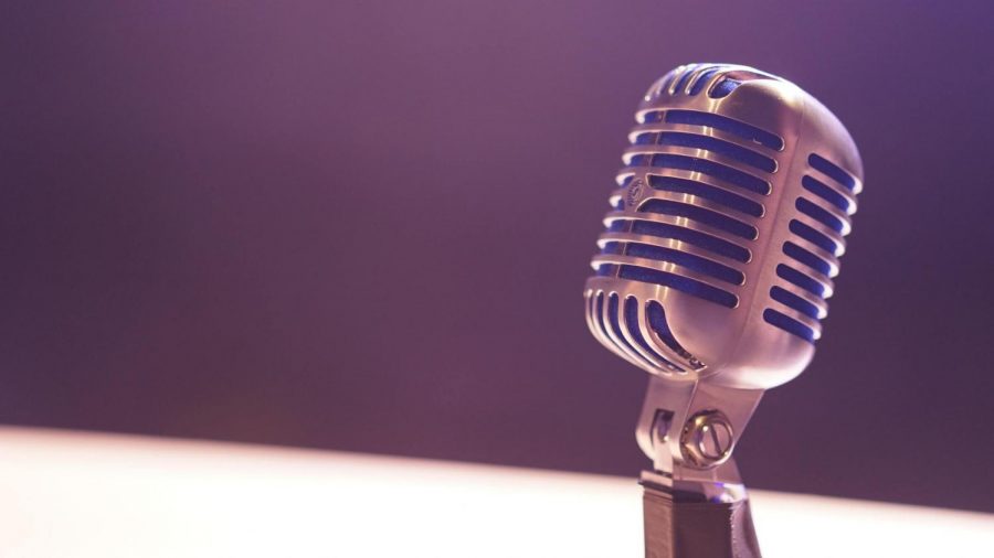 Image of a microphone over a largely neutral background.