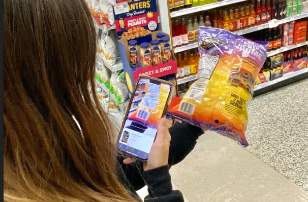  A student scans the barcode of a bag of chips to receive additional nutrition information. The Yuka app allows users to see just how healthy or unhealthy a food or cosmetic item is, purposeful for those conscious about what they’re eating. 