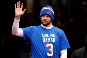 Buffalo Bills quarterback Josh Allen displays his “Love for Damar” T-Shirt in support of Damar Hamlin. The safety went into cardiac arrest after receiving a hard hit from another player. He is recovering and cheering on his team from home.