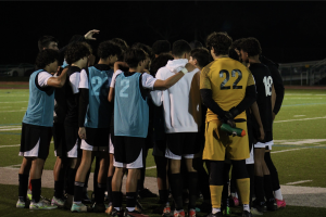 The PPCHS Boys Soccer Team huddles during halftime, crafting a game plan to win the game. The score was 0-0. 