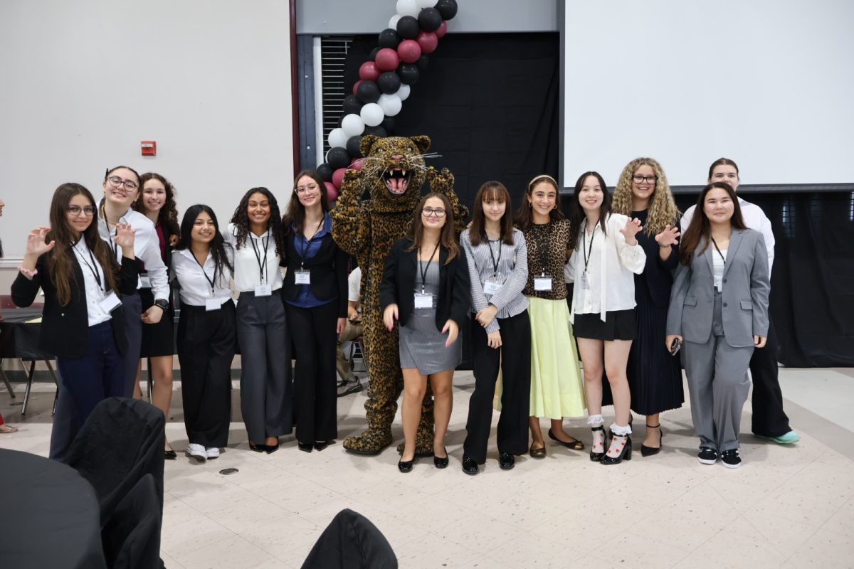 Students from around the county gather at the Academic Village campus to participate in JAGMUN, a Model UN tournament hosted here at PPCHS. Here, students stand next to our jaguar mascot. 