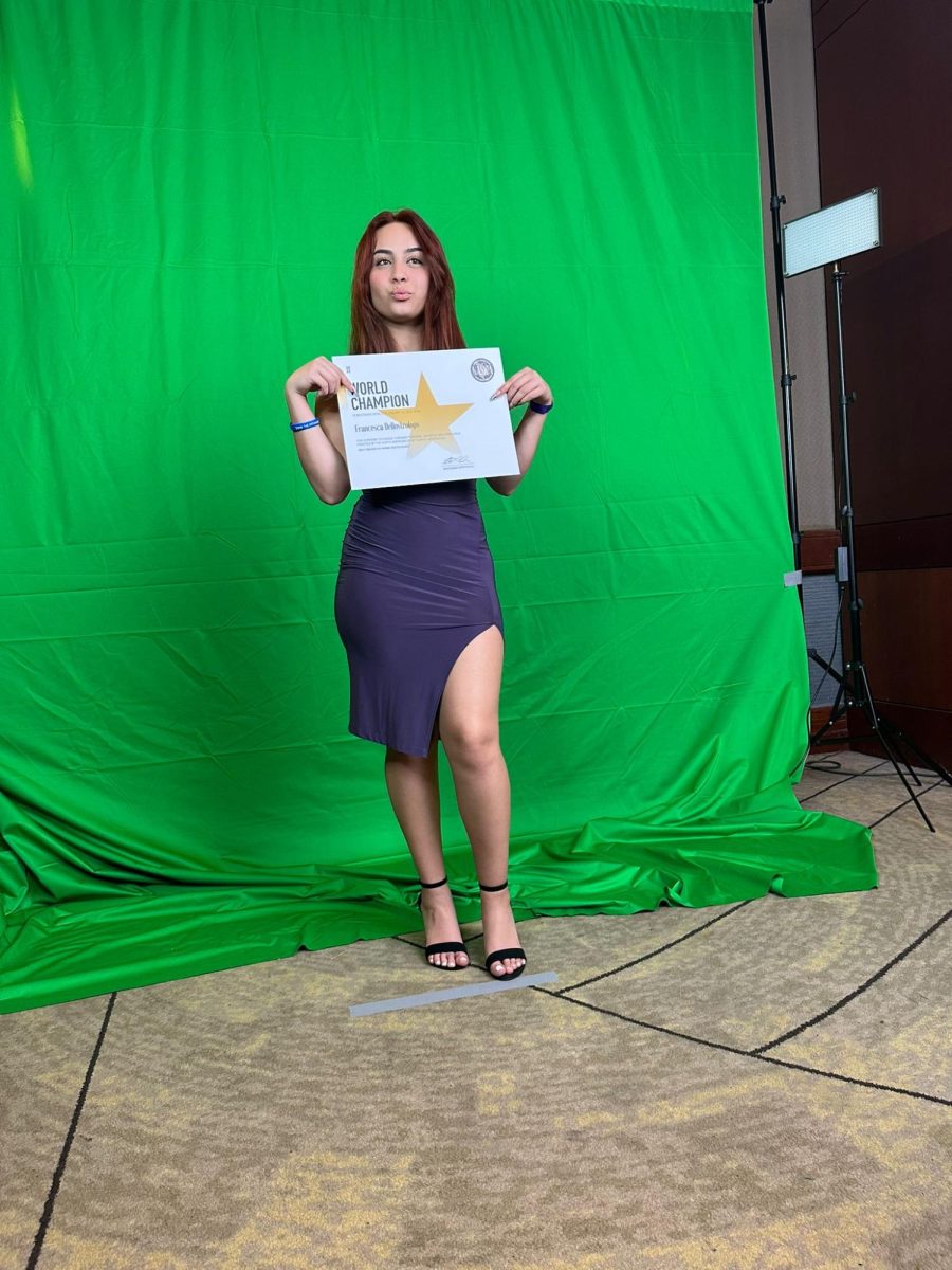 After becoming a World Champion in the martial arts, Francesca Dellostrologo is seen celebrating her win by taking photos after her hardworking win.
