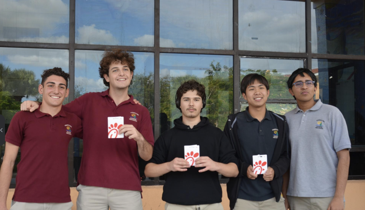 The winners of the Rho Kappa scavenger hunt line up for a photo outside the River of 
Grass theater, holding the prizes ($30 Chick-fil-a gift cards) they won during the event. Each of these students had to correctly answer numerous questions on the subject of psychology, literacy, and history to take home the win. 
