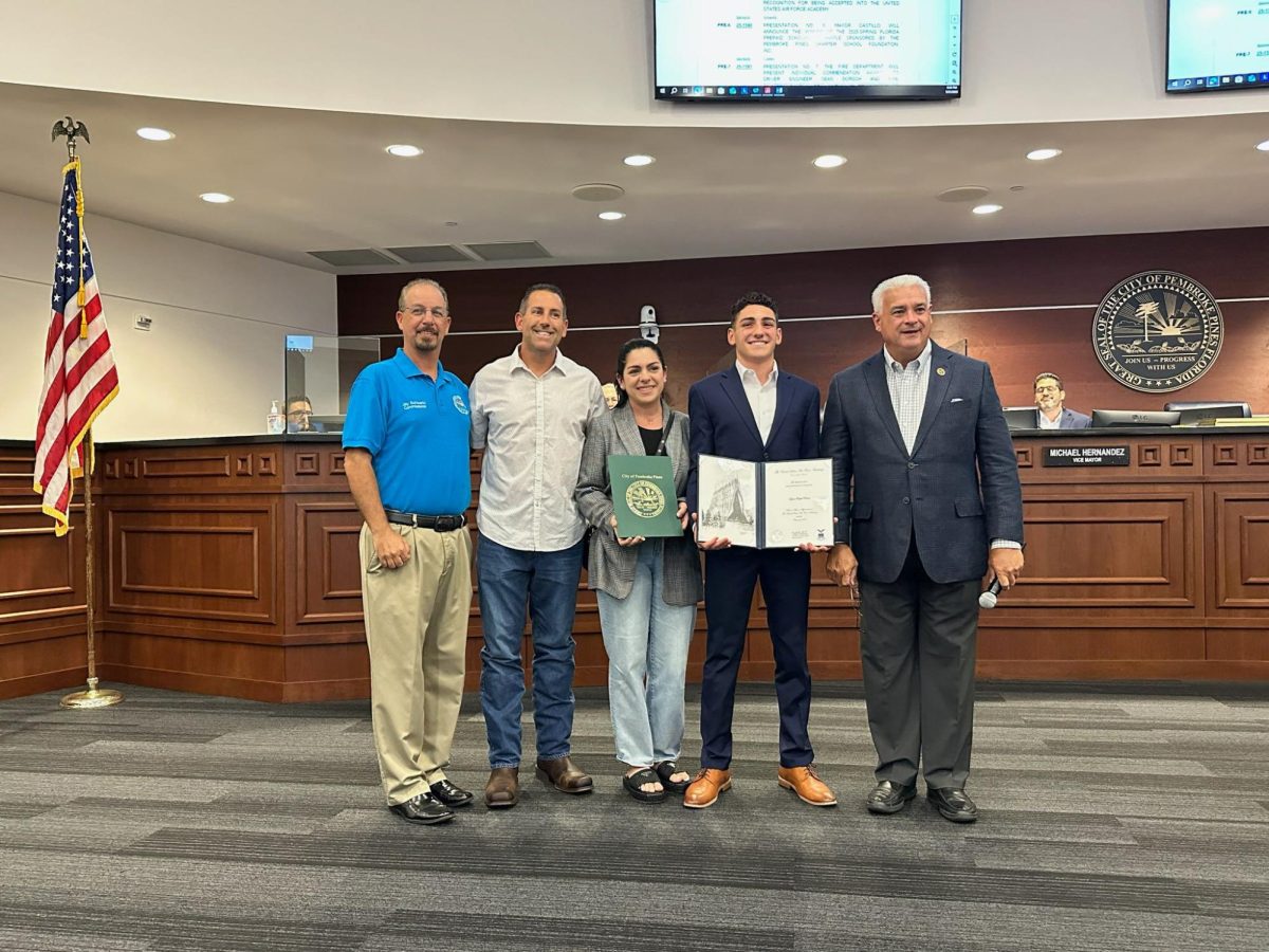 ayden with his parents and the mayor