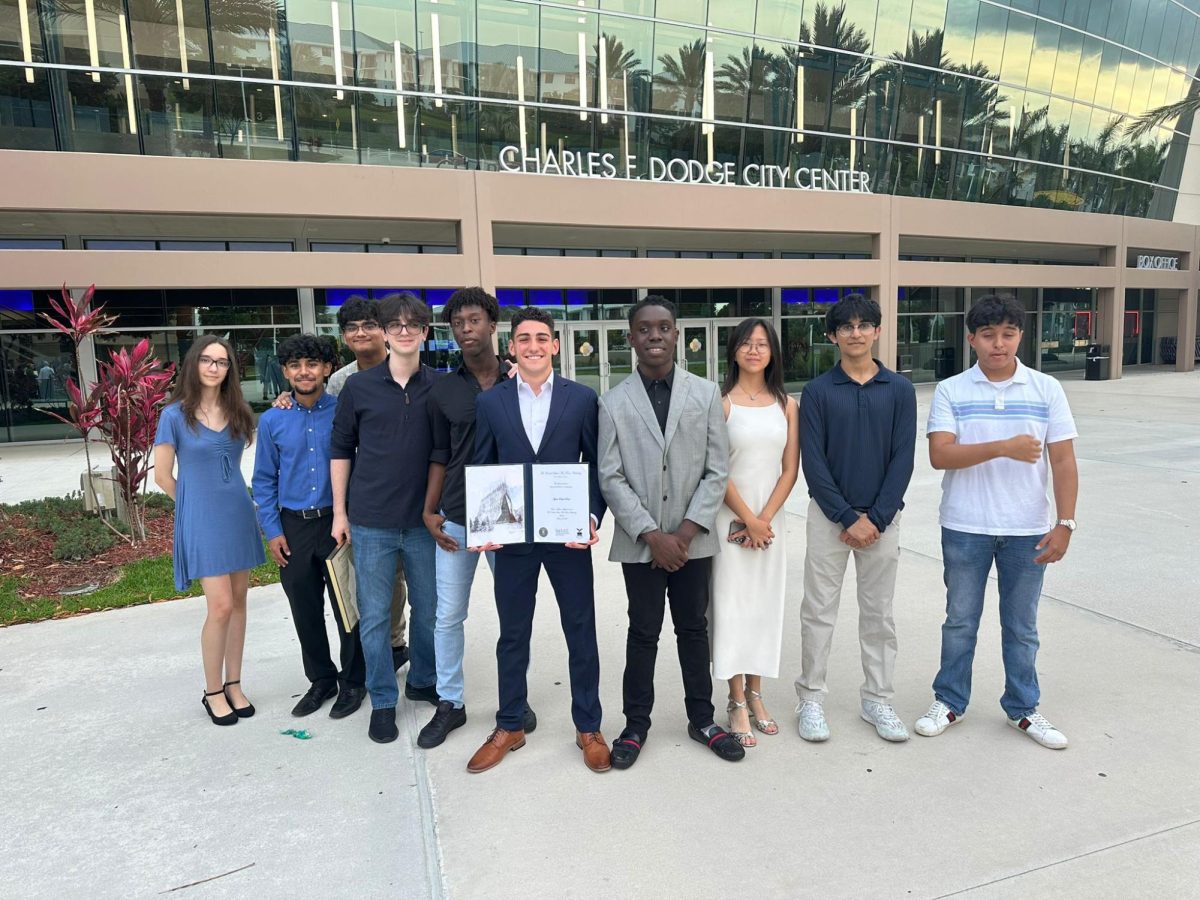Ayden and the rest of the Robotics team stand together outside of the City Dodge Center after they conclude their award ceremony.