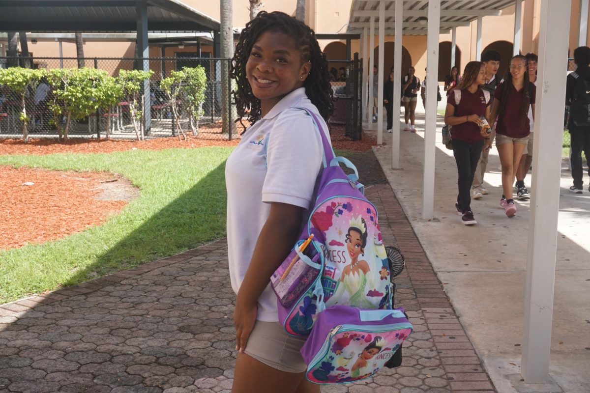 Senior Lealia Taylor holds her Princess-Tiana-themed backpack.