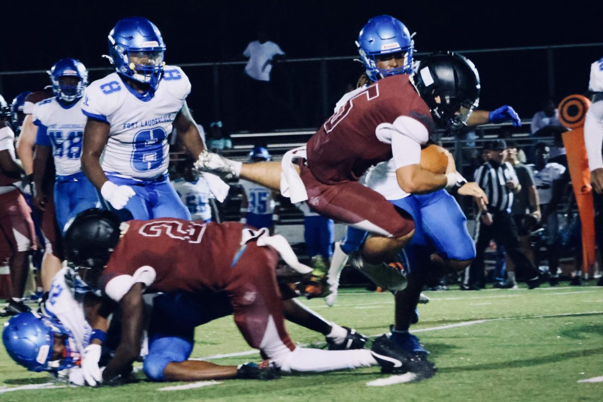 Junior, Trent Beesing, hurdles the defensive line to keep the Jaguars’ drive alive.