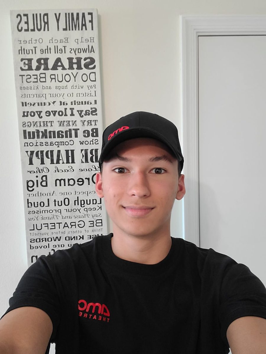 Micah Lopez shows off his AMC theatres uniform that he constantly wore throughout summer for his new job.