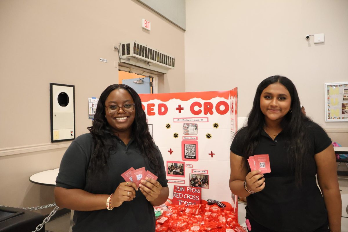 Here are two board members of PPCHS's Red Cross club representing their fun board at Club Fair in order to attract new members. On the left is one of the Co-Vice Presidents Sneha Matthew and on the right is President Eri Fatimilehin.