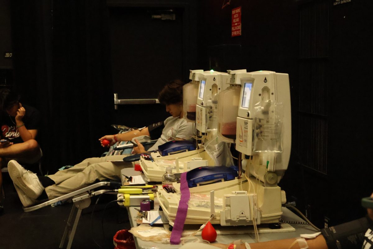 PPCHS senior Angelo Lesmes donates blood on the River of Grass stage. OneBlood and Key Club set up a makeshift office for the safe collection of blood, as seen in the photo.