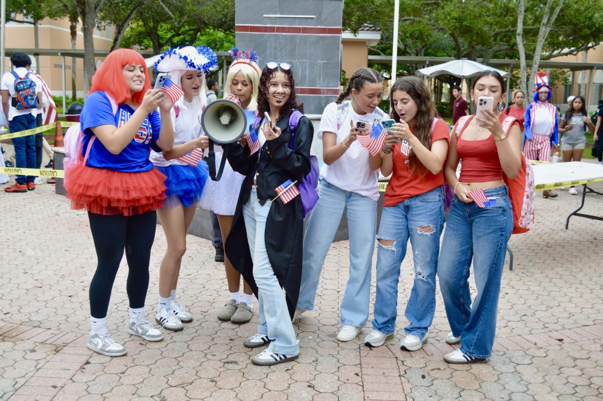 A group of girls quote a section of the Constitution together at the fountain. Together, AP Government seniors form a sense of community on Constitution Day.
Picture by: Paige Hennequin
