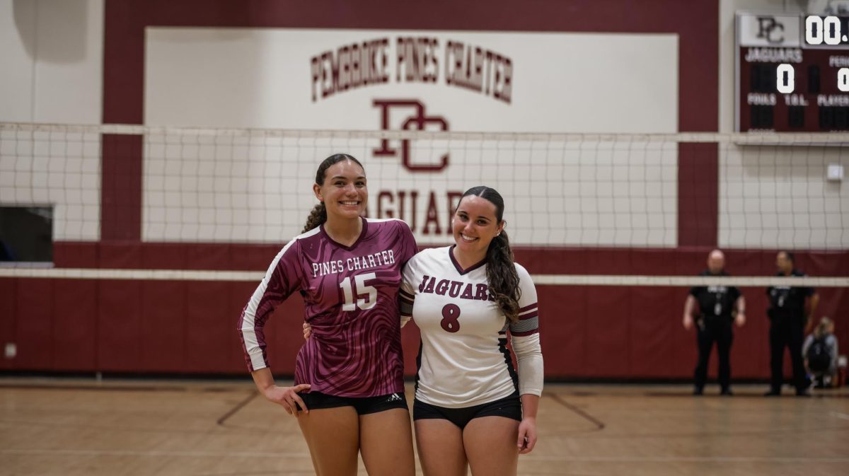 Varsity Volleyball Senior Abigail Reyolds [left] standing alongside her fellow teammate and captain of the team Senior Sophia Peterseil before their game.