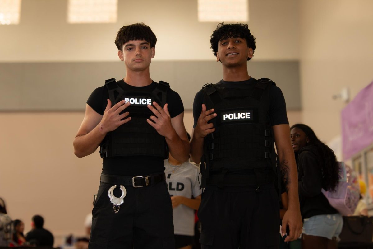 Two students match as police officers for the final day of Spirit Week.
