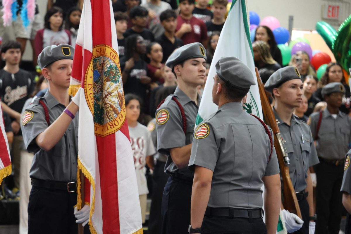 Charter's Military Leadership club presents flags for their ceremony.

