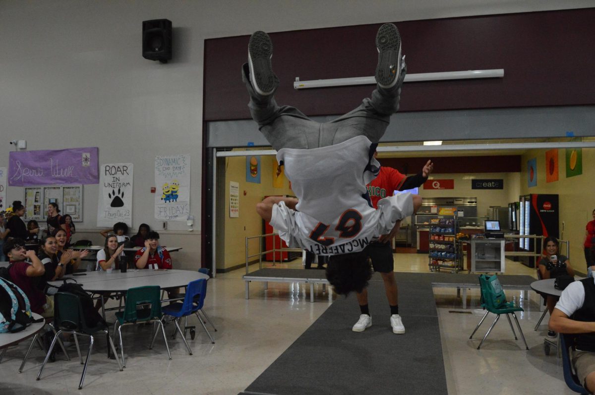 A PPCHS student does a backflip on the catwalk, set up in the cafeteria during A and B lunches.
