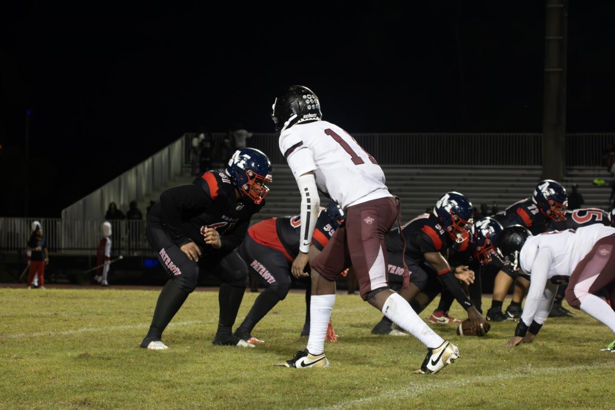 Senior Adon Hollingshed preparing to defend against Miramar High School Football team's offensive drive under the Friday night lights