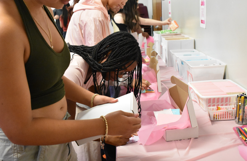 Jazmyn Walcott writing down a note to the future owner of her cosmetic box, spreading clarity and ensuring that PHP members are ready to help.
