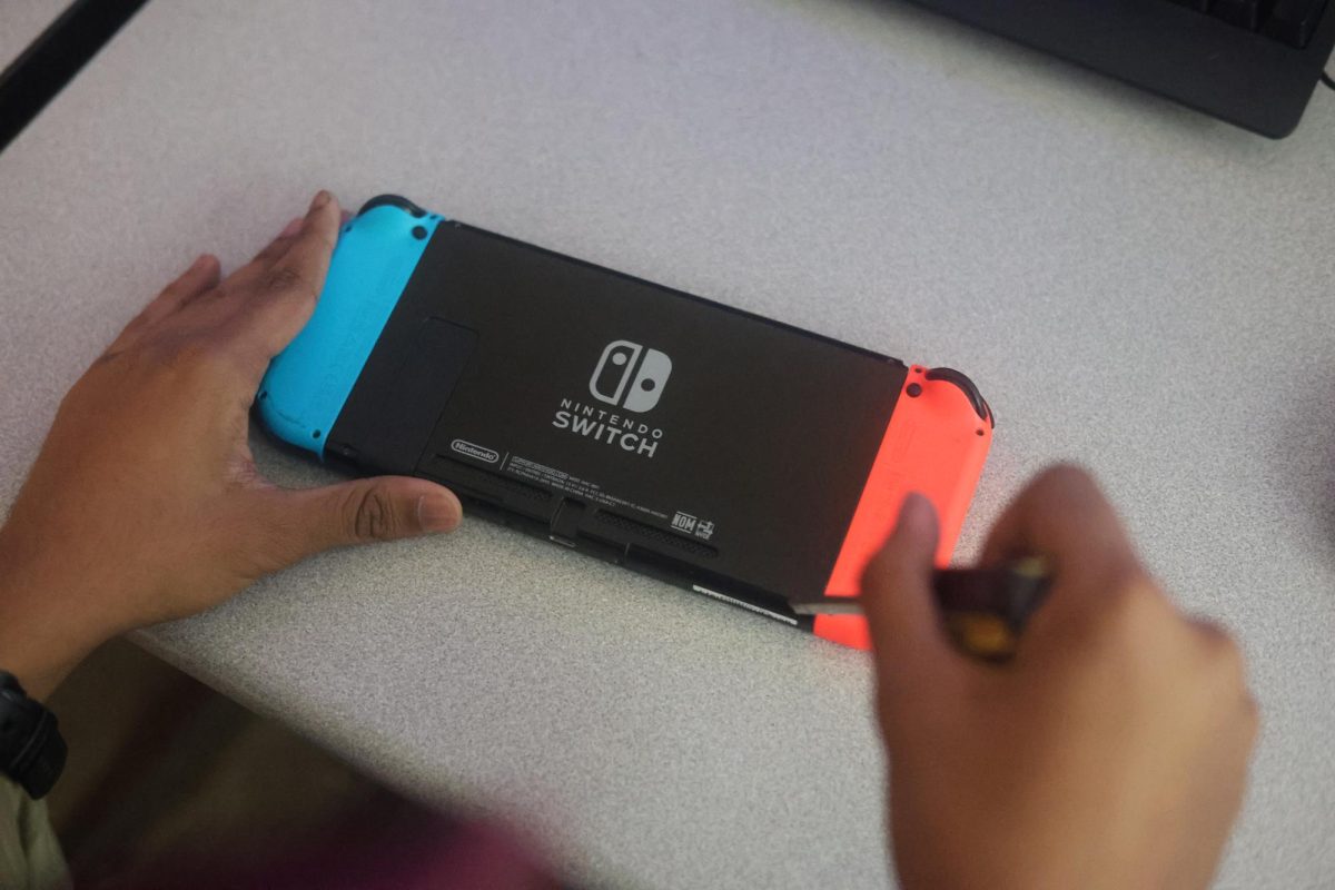 A PPCHS student modifies his Nintendo Switch. Many gamers have resorted to changing software to keep their hobby affordable.