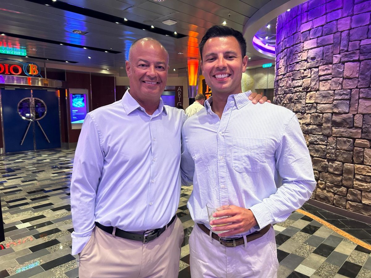 Security Guard Manny Alayon (pictured left) stands next to his son, Brett Alayon (pictured right). Together they commemorate the 60th birthday and retirement of Sally Alayon, Manny's wife and Brett's mother, following her 35-year career with the Miami-Dade County Public School System.