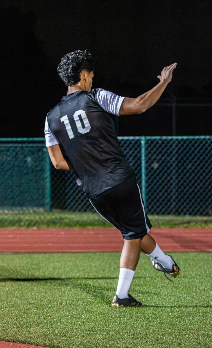 Senior Gabriel Calderon as he passes the ball while thinking of his next move as no opponents surround him.