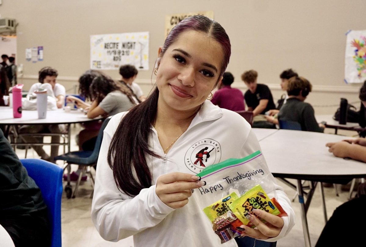 Sophomore Camila Rivera holds a bag of candy in the cafeteria. Along with roses, the CHAT distributed candy to show appreciation for PPCHS.