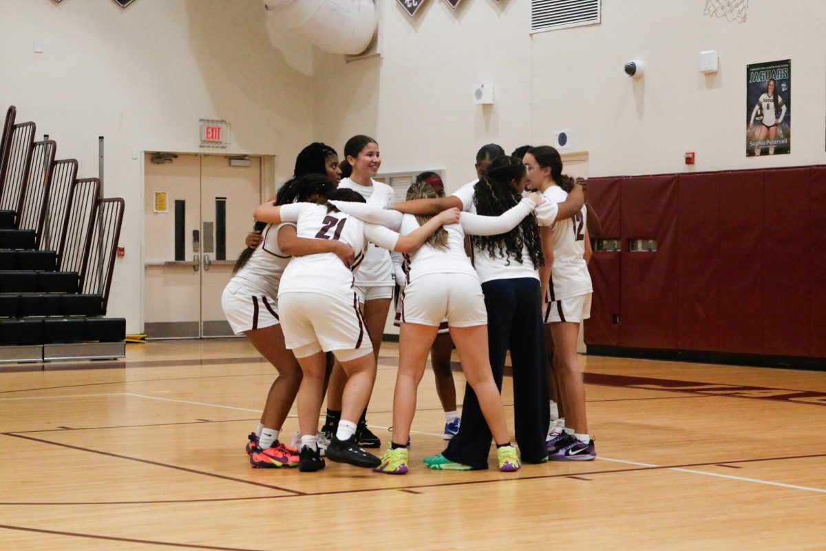 The Lady Jags as they prepare for the tip-off of their game. They stand along each other to show support and mentally prepare for their upcoming game.