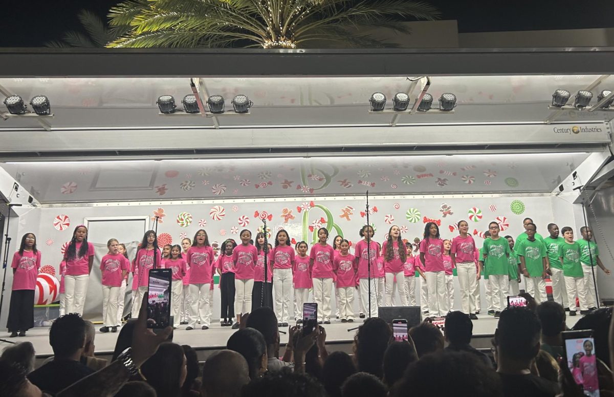 A group of an elementary school choir singing classic Christmas songs. Making their parents proud, these talented kids lit the night with holiday cheer and big smiles.