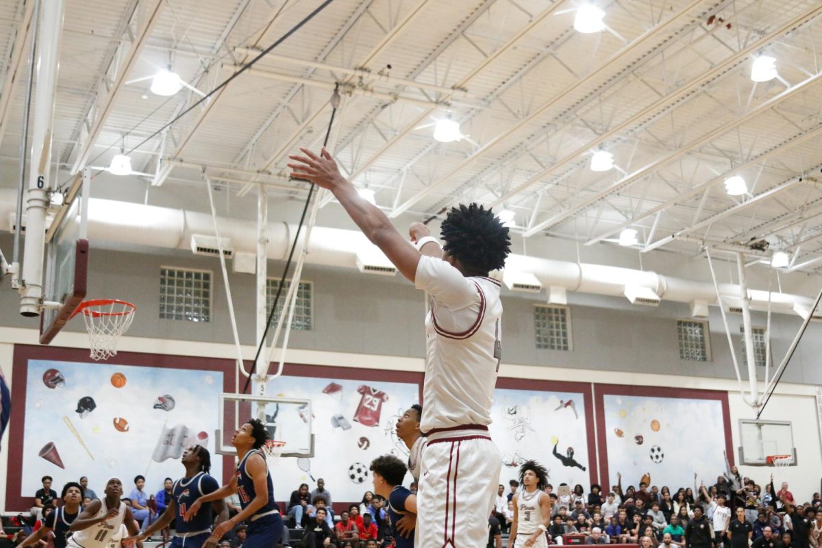 Jacob Trenchfield [#4] as he makes a three-point shot for the Jaguars as he leads them past Chaminade Madonna High School at their home opener.