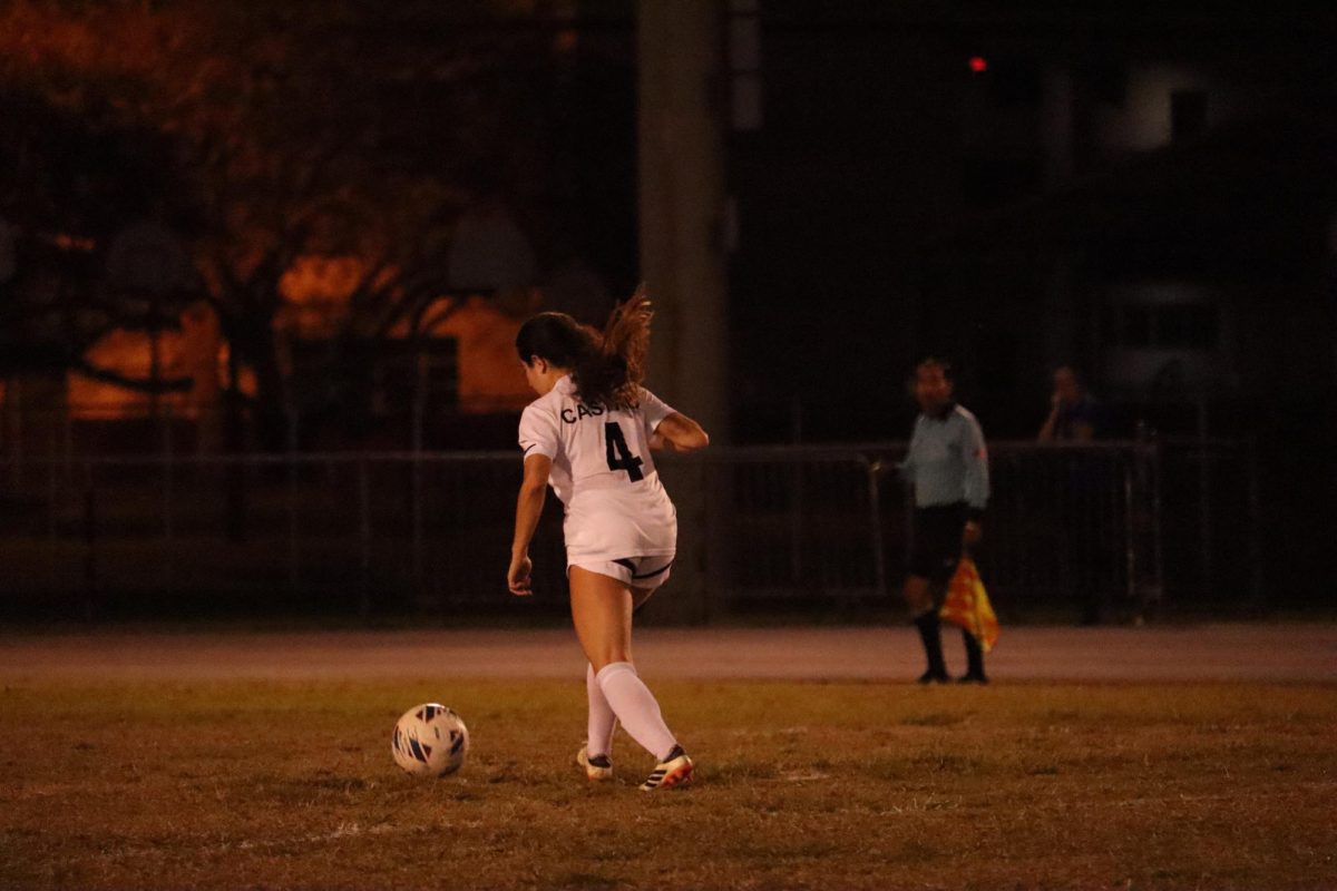 Senior Cata Castro as she dribbles the ball during the game against Marjory Stoneman Douglas High School with one thought in her mind: get the Jaguar victory.
