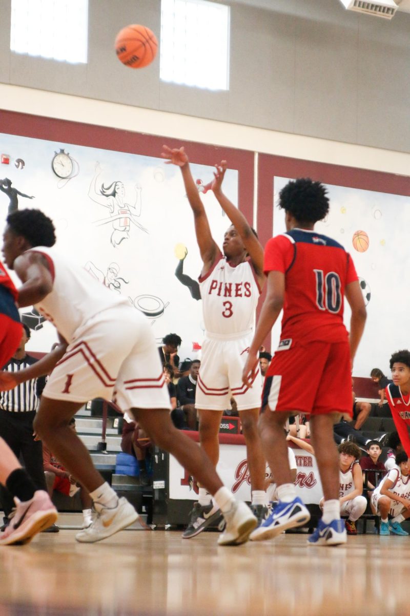 Sophomore Jayden Coote as he shoots the ball at the JV Jags basketball team's home opener aiding their lead over Chaminade Madonna High School.