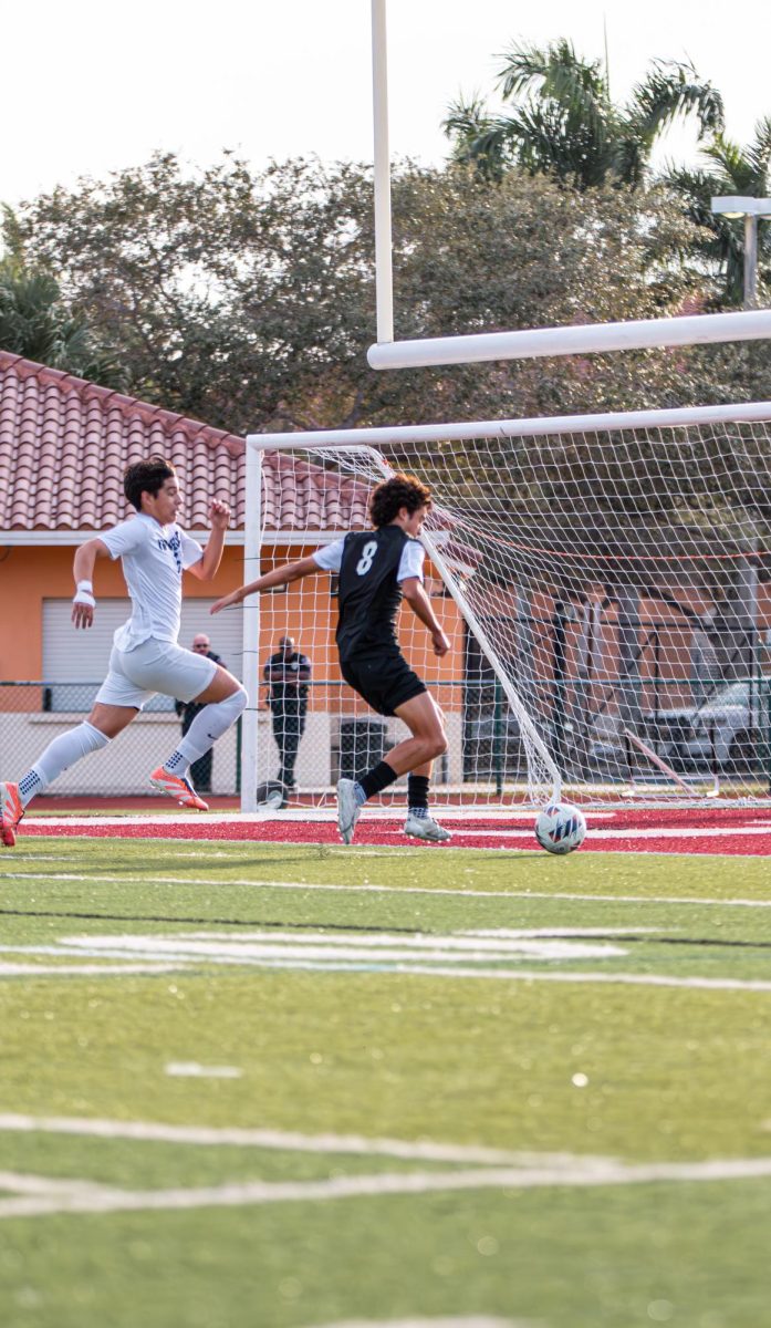 Senior Julian Iodice [#8] as he attempts to score a goal for the Jaguars soccer team.
