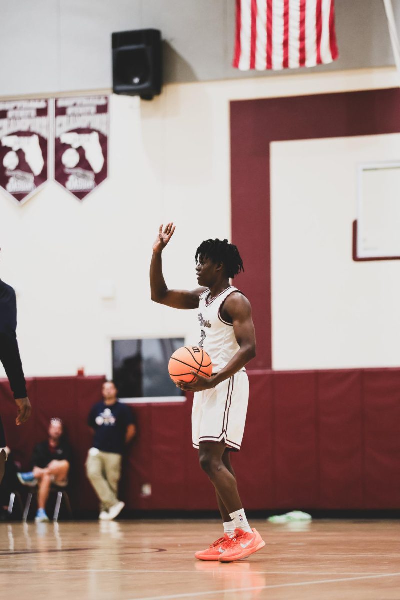 Junior Zacuras Dawson as he dribbles the ball and leads the Jaguars as a captain on the court.
