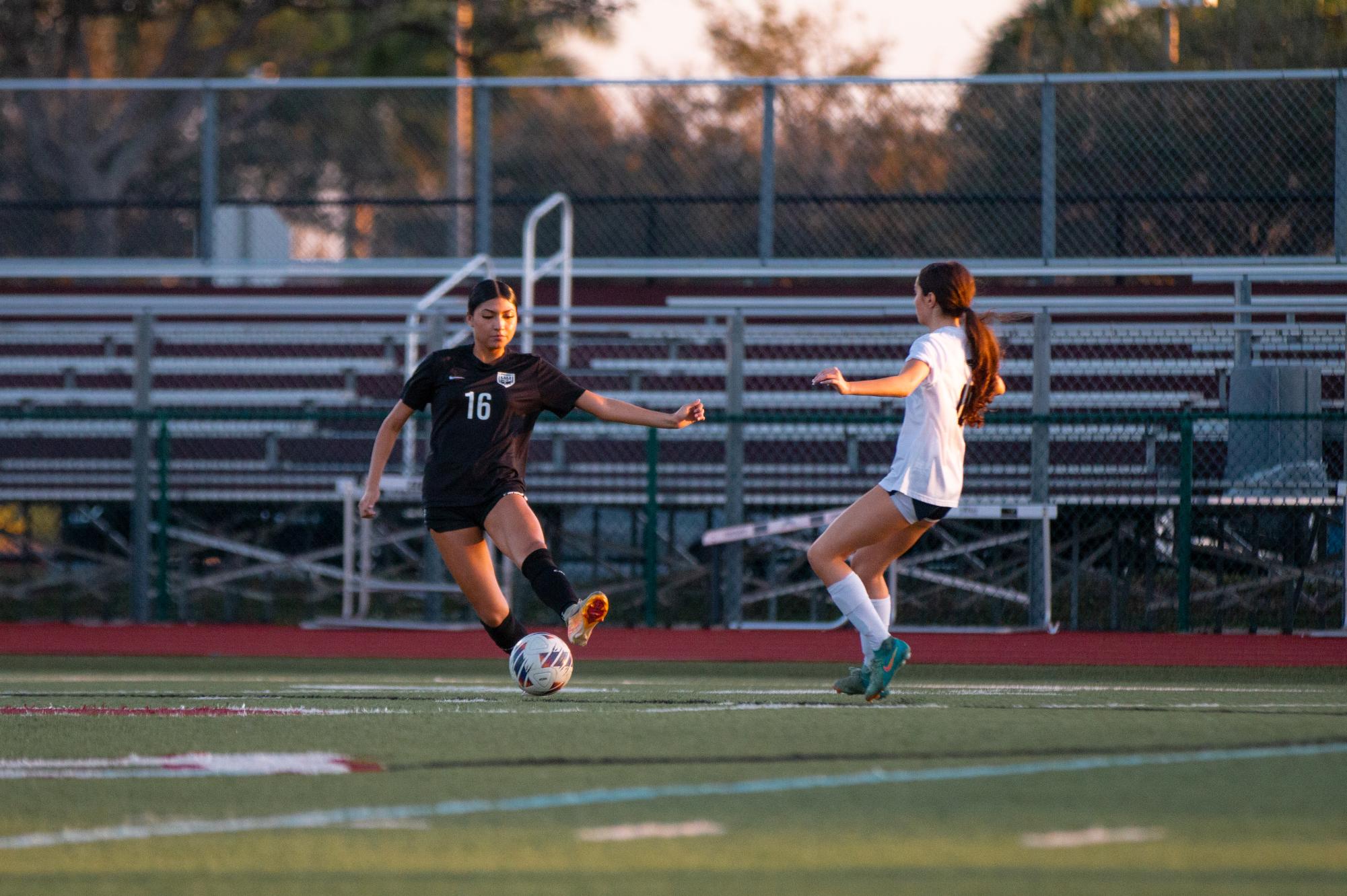 Junior Taliyah Gavilanes [#16] as she attempts to stop the soccer ball from going to the opponent, potentially saving her team from the opponents scoring a goal. 