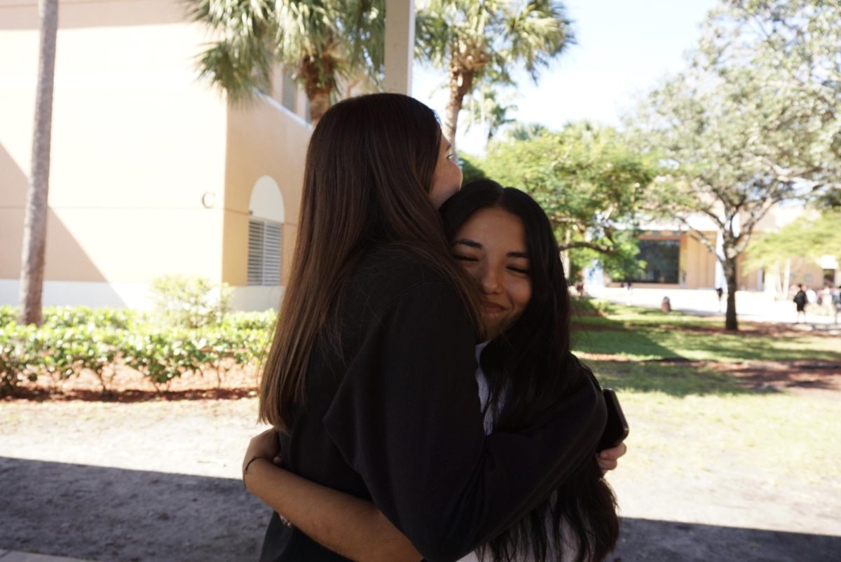 Best friends Caroline Curl and Gabriela Godoy hug each other, expressing their joy in being in a friendship after years of hardship and compassion.
