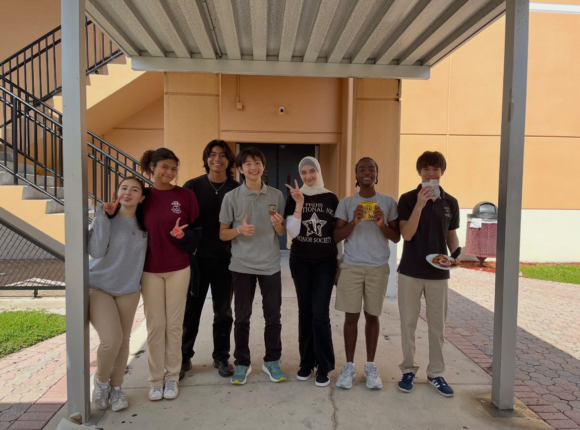 Transfer student Yuki Yoshida (center) stands outside the C Building at lunch with friends on his final day at PPCHS. Over the two-week period, Yoshida made dozens of new friends on campus, many of whom he would visit again when he returned over winter break for his birthday.