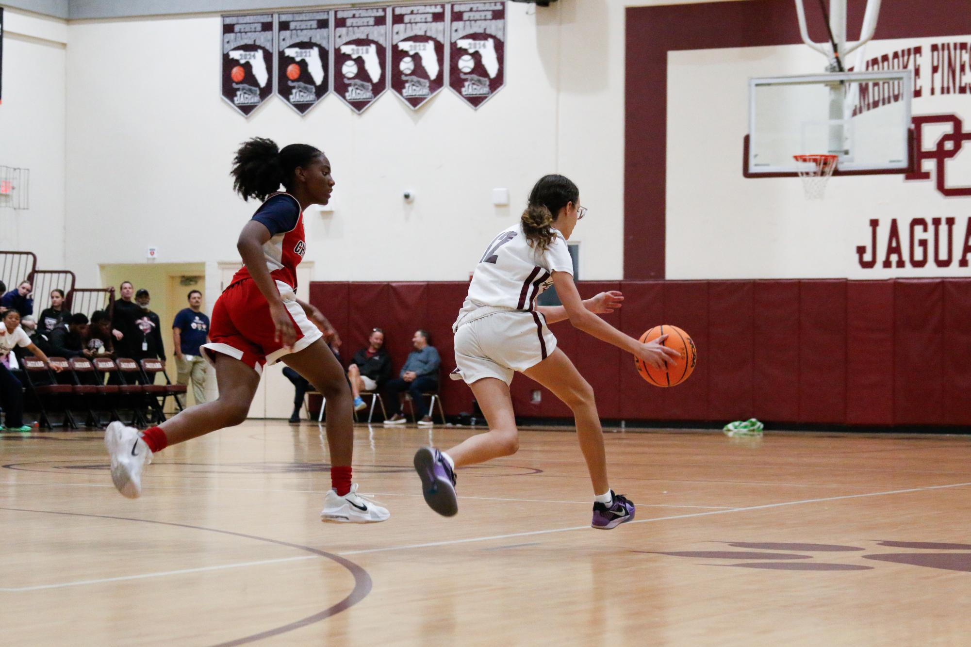 Freshman Myah Mendez dribbling the basketball during a home game for the Lady Jags.