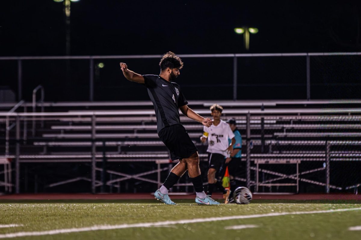 Senior Arjun Nambiar kicks the ball during the Jaguars soccer team's game.