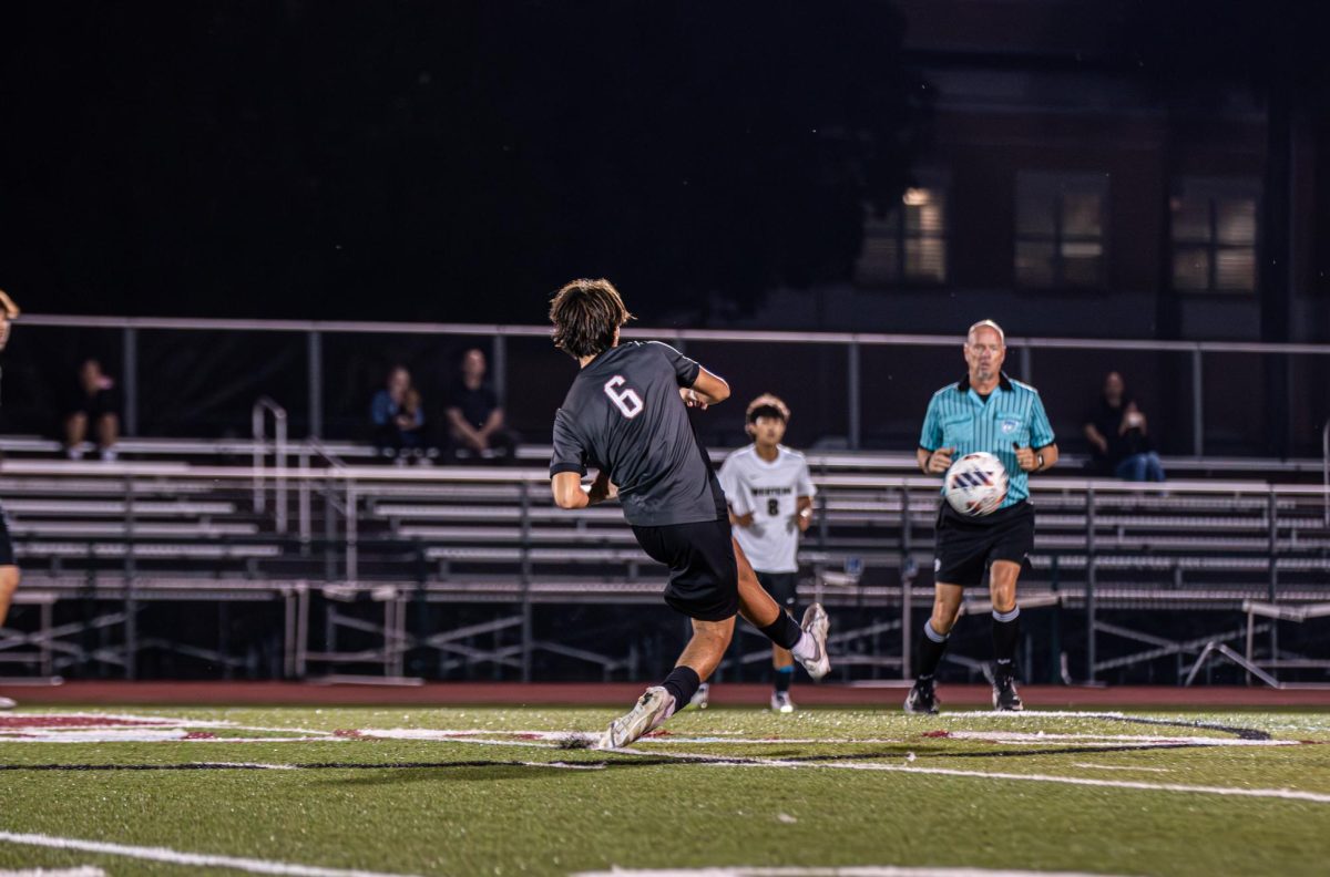 Junior Emerson Toledo as he kicks off the Jaguar's soccer team's home game with hopes of a Jaguar victory.