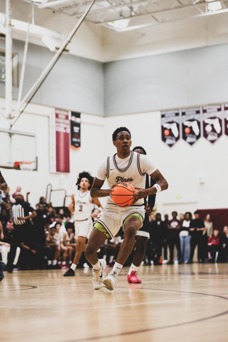 Junior Anthony Walcott as he passes the basketball during a game with the main goal in mind: victory.