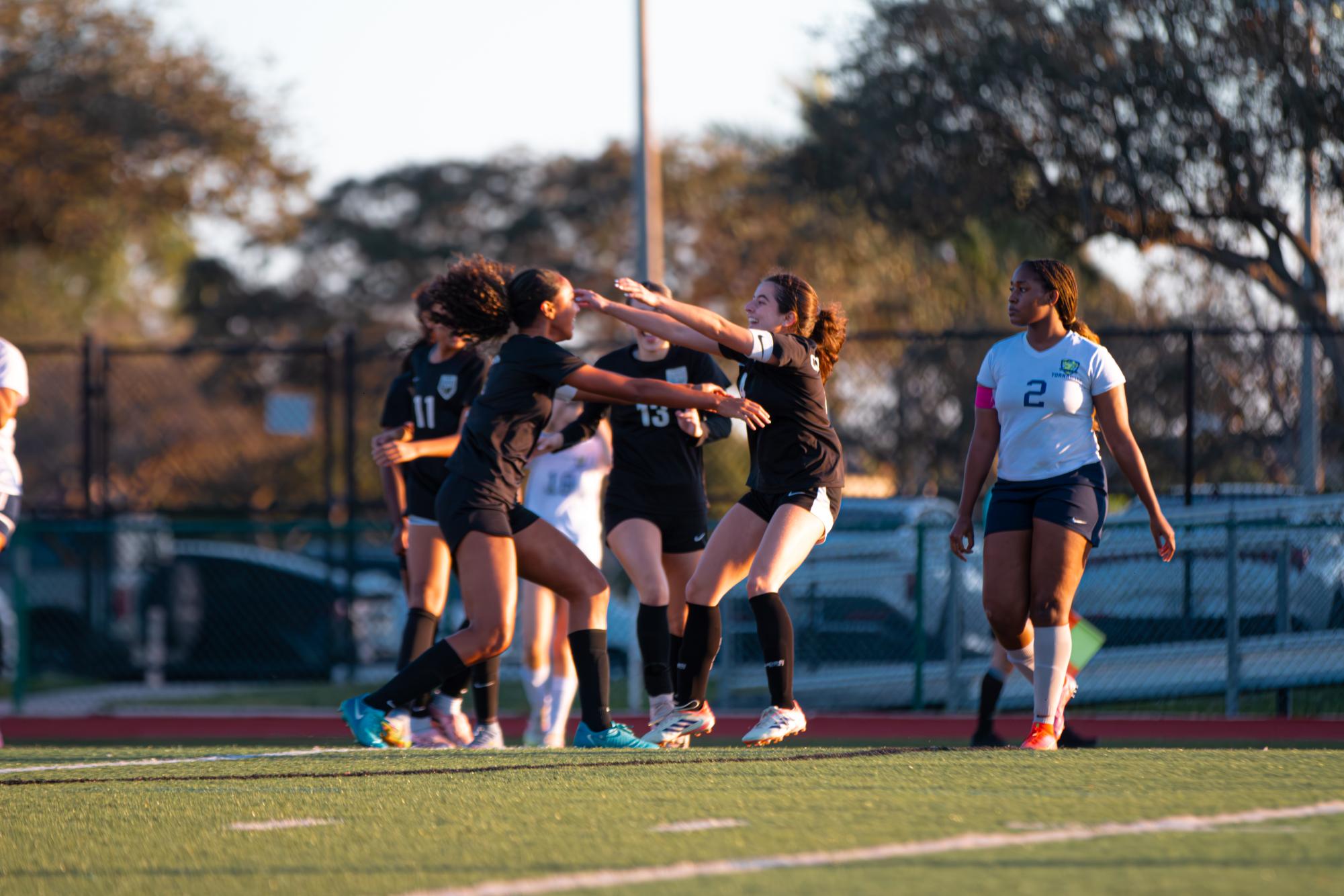 Seniors Catalina Castro [right] and Amariah Ayum [left] hug each other after Castro scored a goal.
