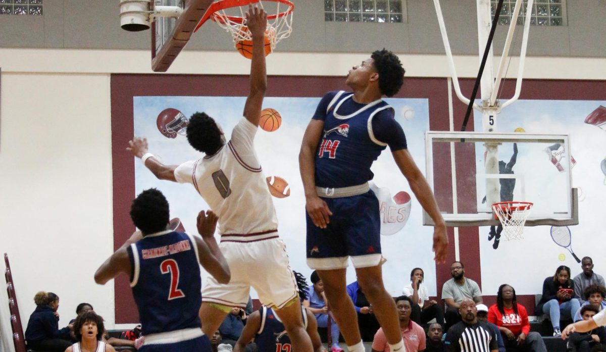 Junior Anthony Walcott dunking the basketball with power, thought, and force.