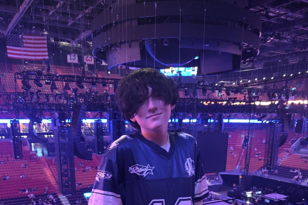 Dexter Kraker stands next to a stage and gets ready for a concert of one of his favorite artists. He expresses how excited he is and is ready to scream out all the songs.