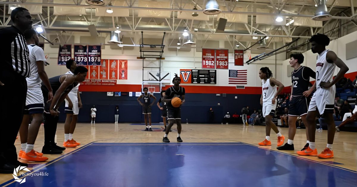 Dawson (in the center of the photo) as he stands on the free-throw line preparing to make a free throw.