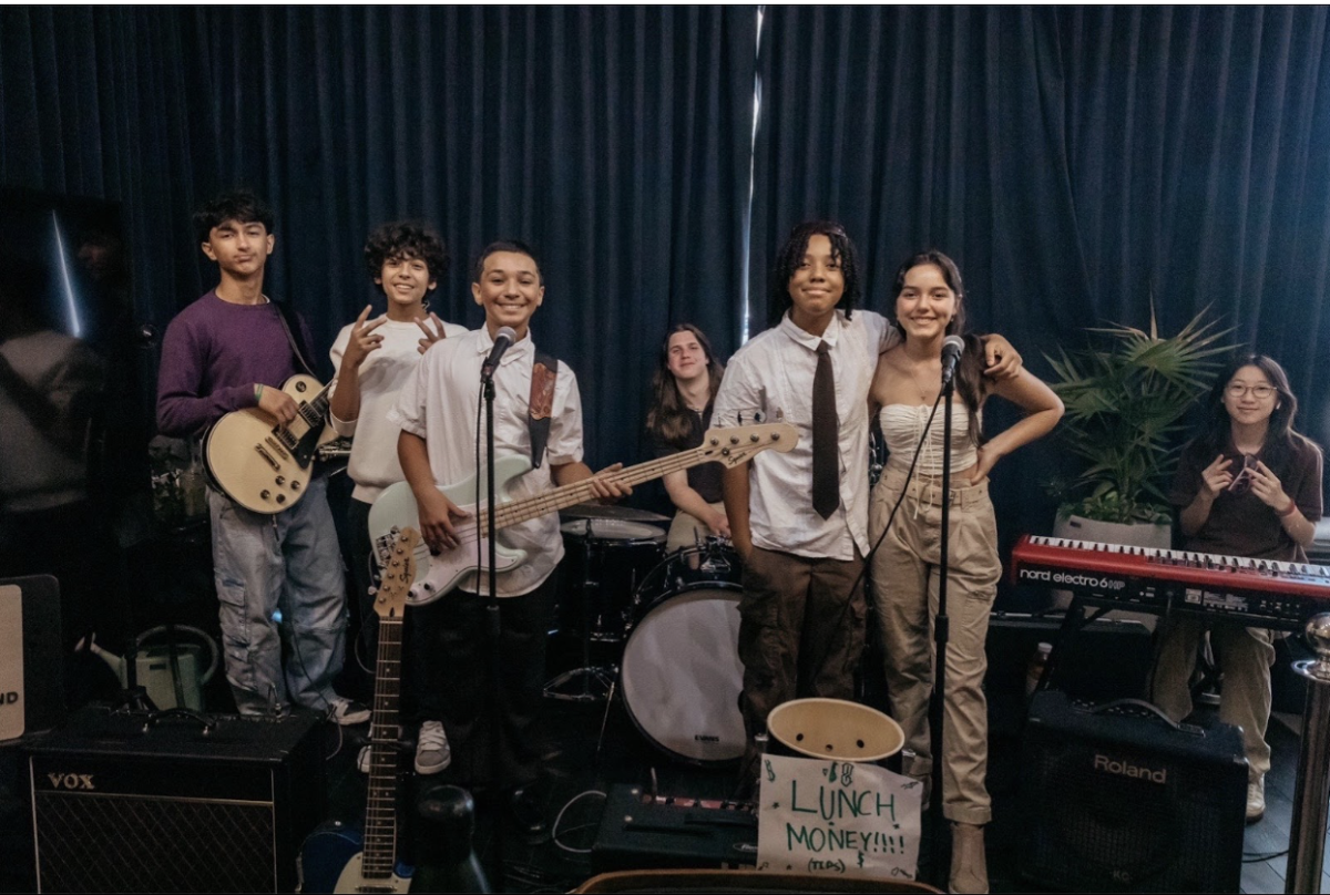 Ayanna Ottley (3rd from the left) and her bandmates, called the ‘Lake House’ smile and pose for a photo. After showcasing their talents for fans and viewers at Josefina’s Coffee House, their smiles show the happiness performing music can bring. 
