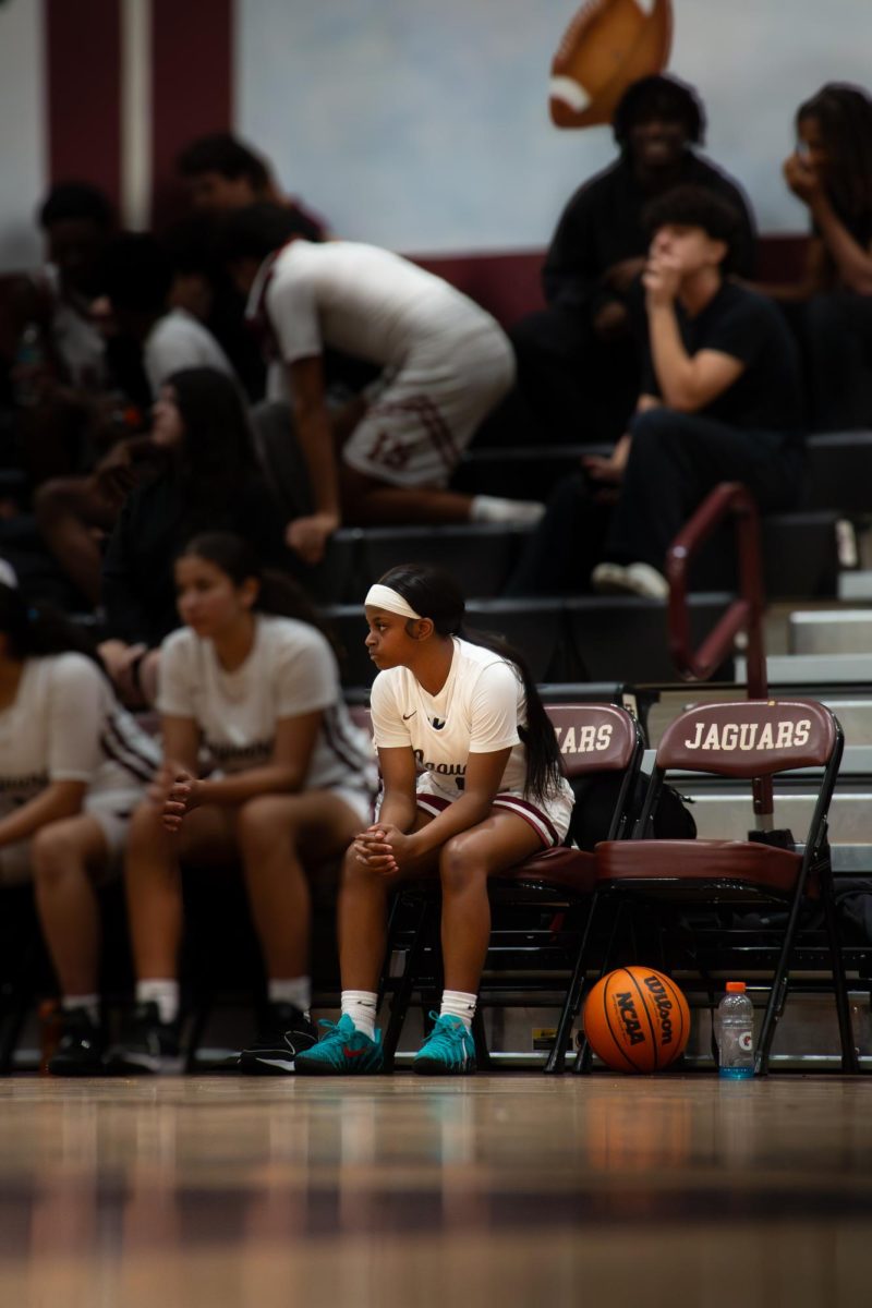 Harmony Destine sits along the sideline during a game observing and feeding on their weaknesses.
