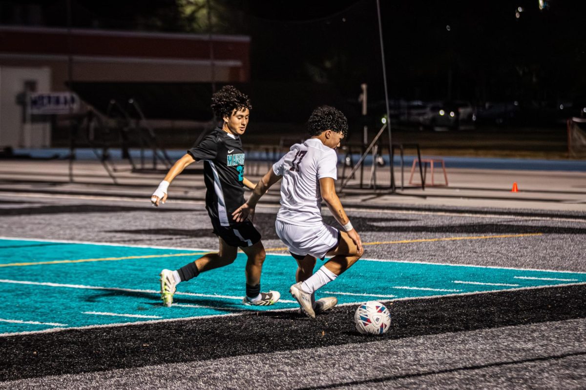 Jason Marfan (#17) keeping possession of the soccer ball as he avoids the opponent.