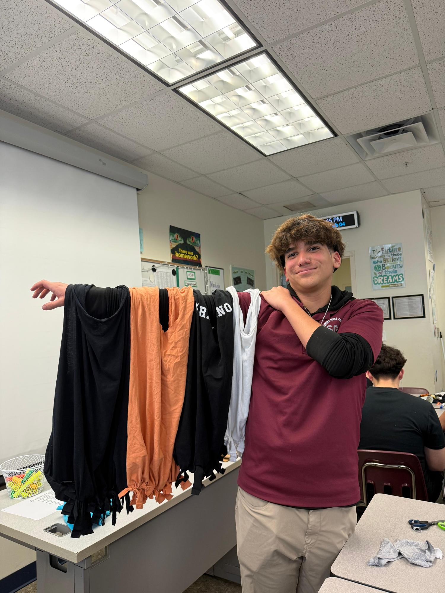 Junior, Alex Rivera is shown with his multiple shirts made from PPCHS’s tote bag making event during environmental week.
