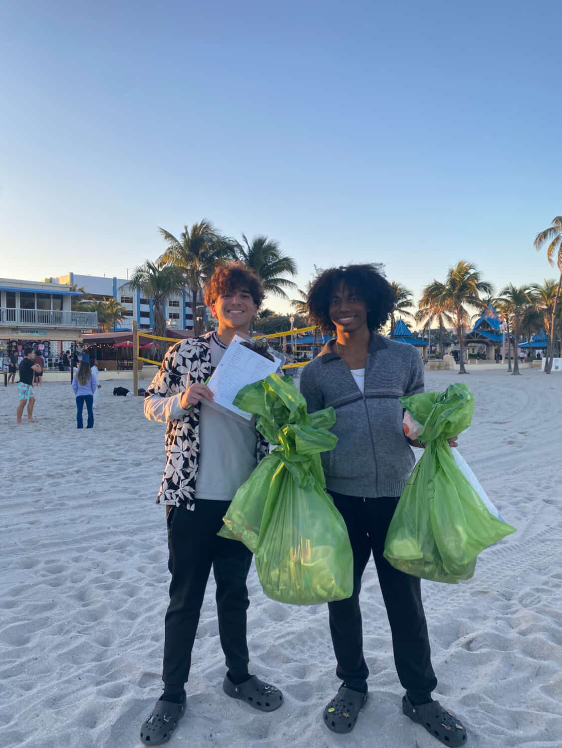 Junior, Alex Rivera (on the left) and Senior, Xavier Reid-Morgan (on the right) present themselves holding the trash that they gathered while coming together for their annual beach clean up event.

