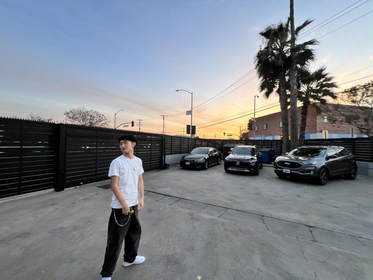 Junior Henri Humar stands in the center of a parking lot in California. Humar served as the assistant production manager for Tether Production during a weeklong shoot on the West Coast.