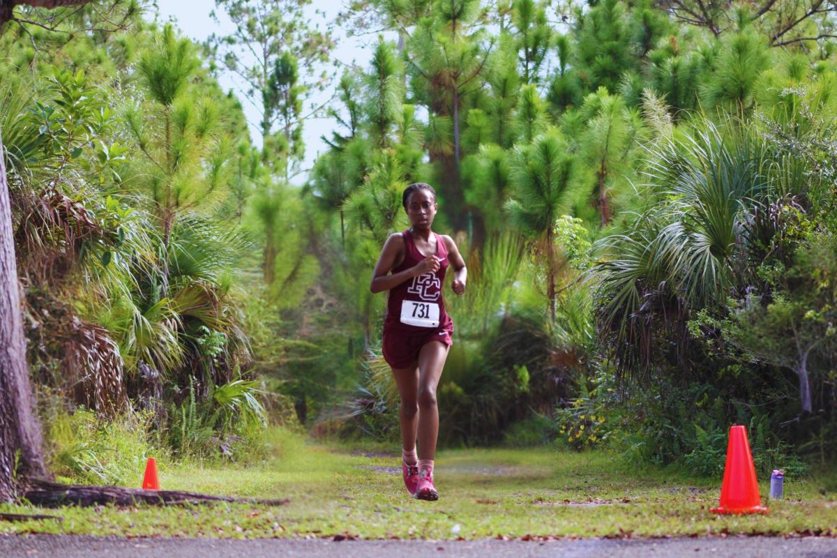 Alyssa Salmon is sprinting to the finish line at a meet. With every step she takes, she represents Jaguar Nation, making sure to leave her mark.